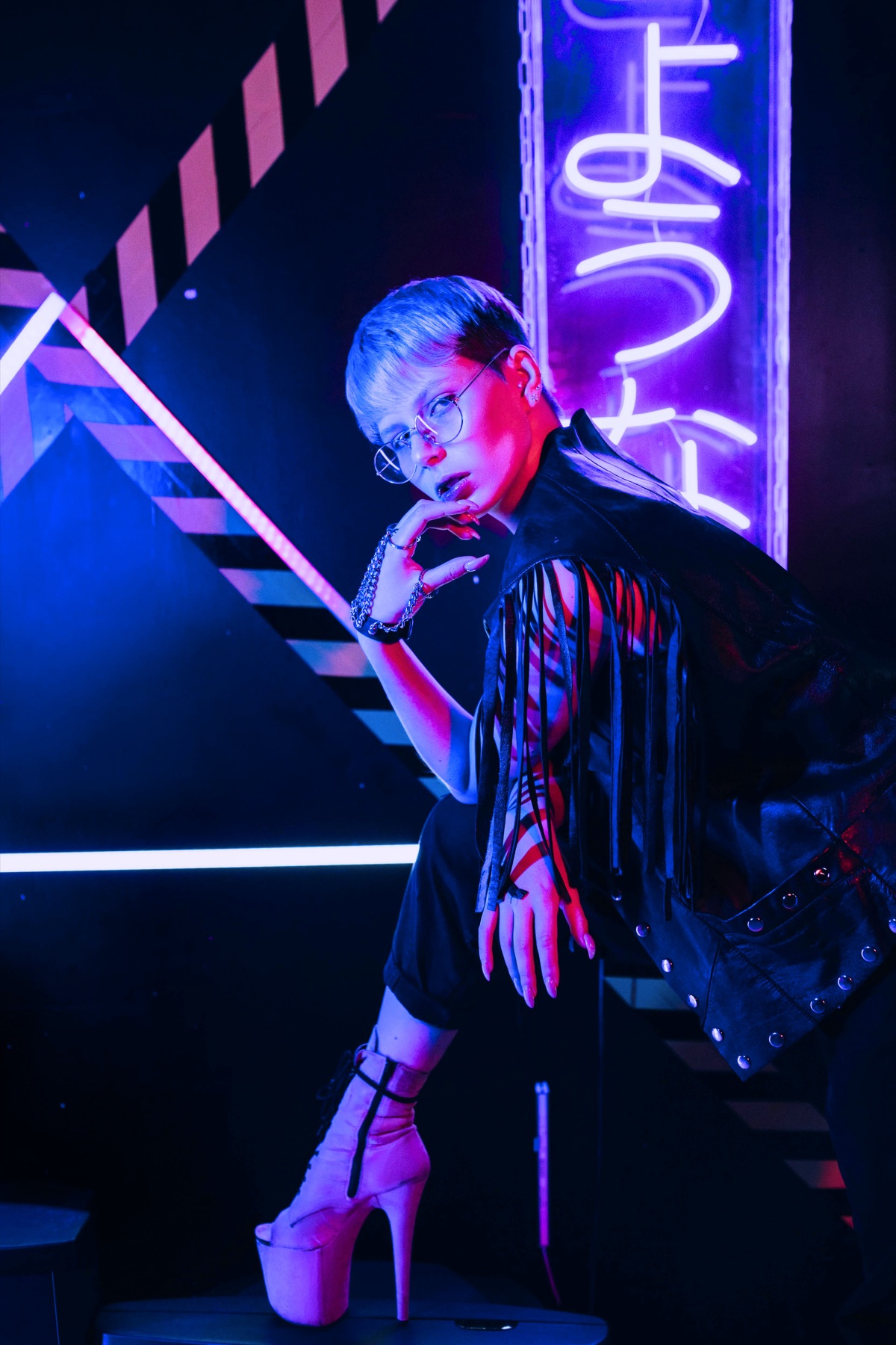 Androgynous queer portrait under neon lights